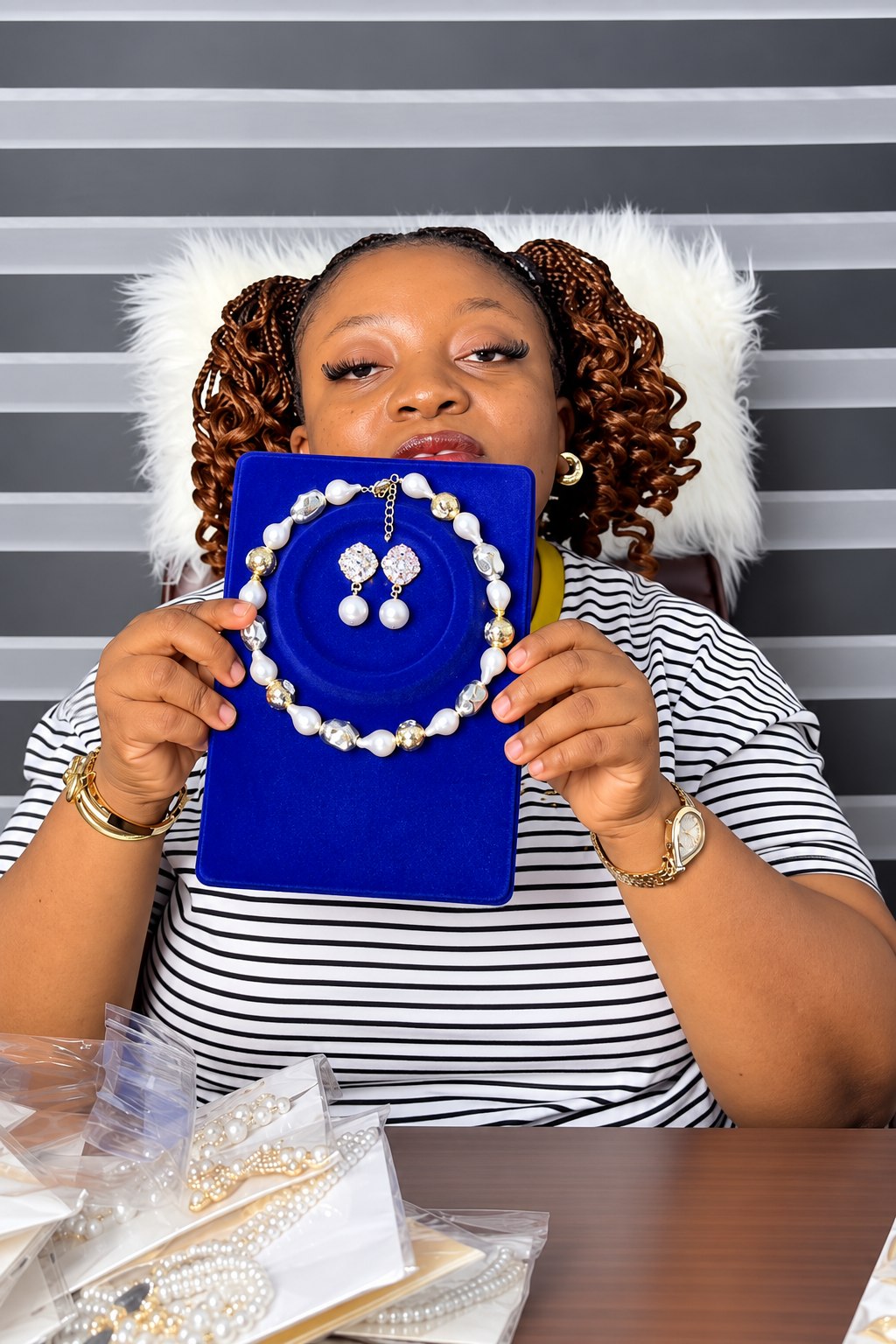 Amara presenting a pearl set on blue velvet